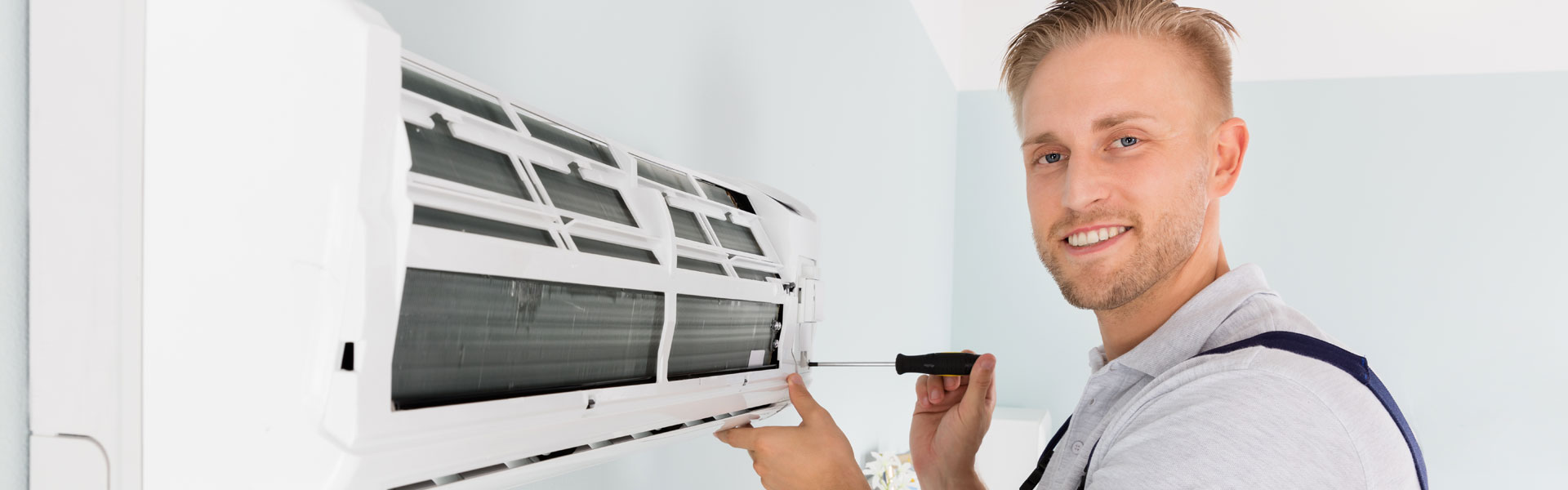 Technician Fixing Air Conditioner